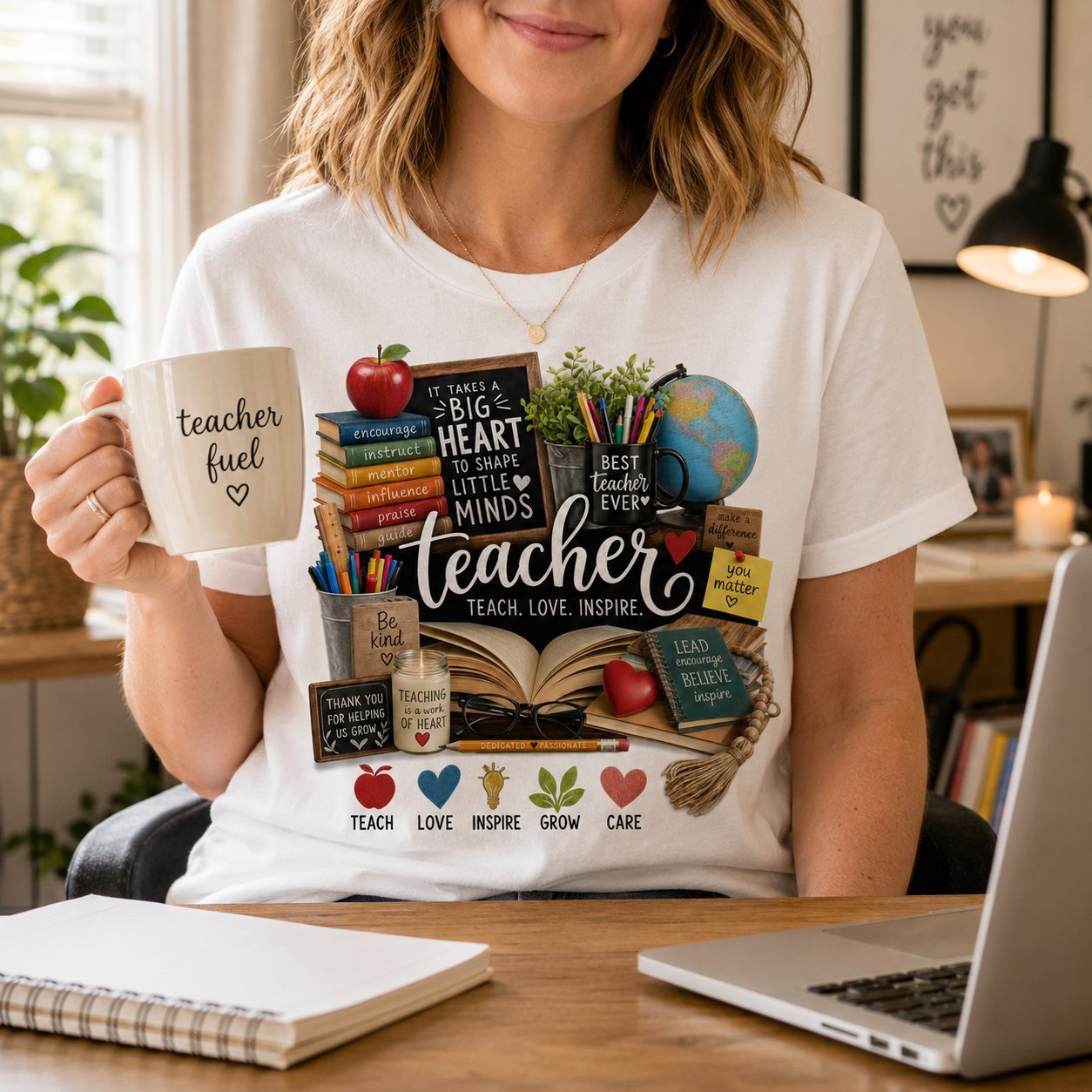 Woman wearing a white teacher appreciation t-shirt at a desk while holding a mug that reads teacher fuel
