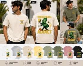 Sand colored t-shirt with Pickleball Addict pickle mascot design, shown with 8 available colors